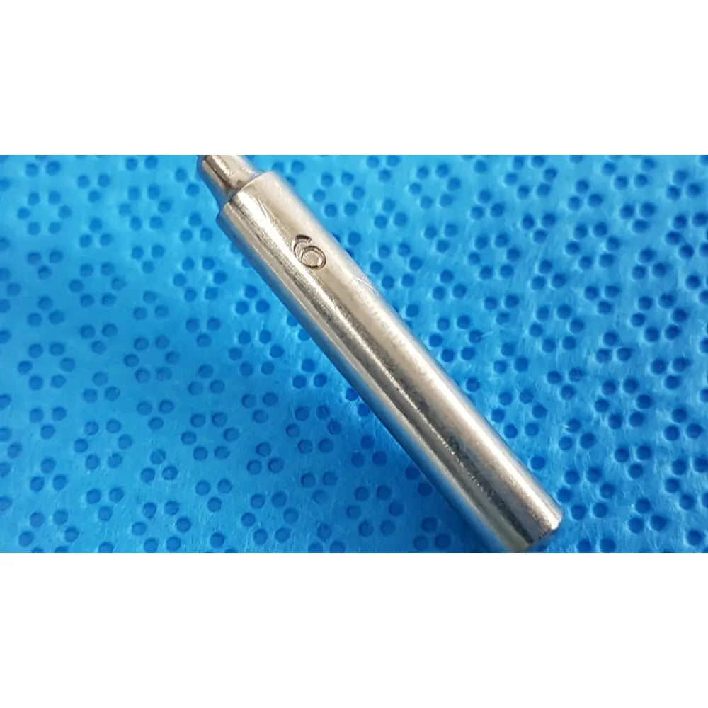 Silver-colored metal drill bit with pointed tip marked 6 in the codman debakey mall surgical instrument set