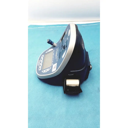 Blue and silver handheld colin press-mate prodigy ii 2240 patient monitor with digital display, control buttons, and cuff attached