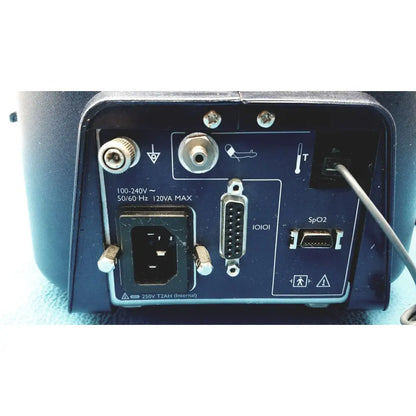 Dark blue rear panel of colin press-mate prodigy ii 2240 patient monitor with power input serial and spo2 sensor ports