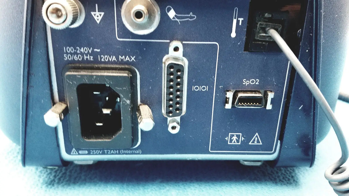 Rear panel of blue colin press-mate prodigy ii 2240 patient monitor with power input serial port and spo2 sensor connector