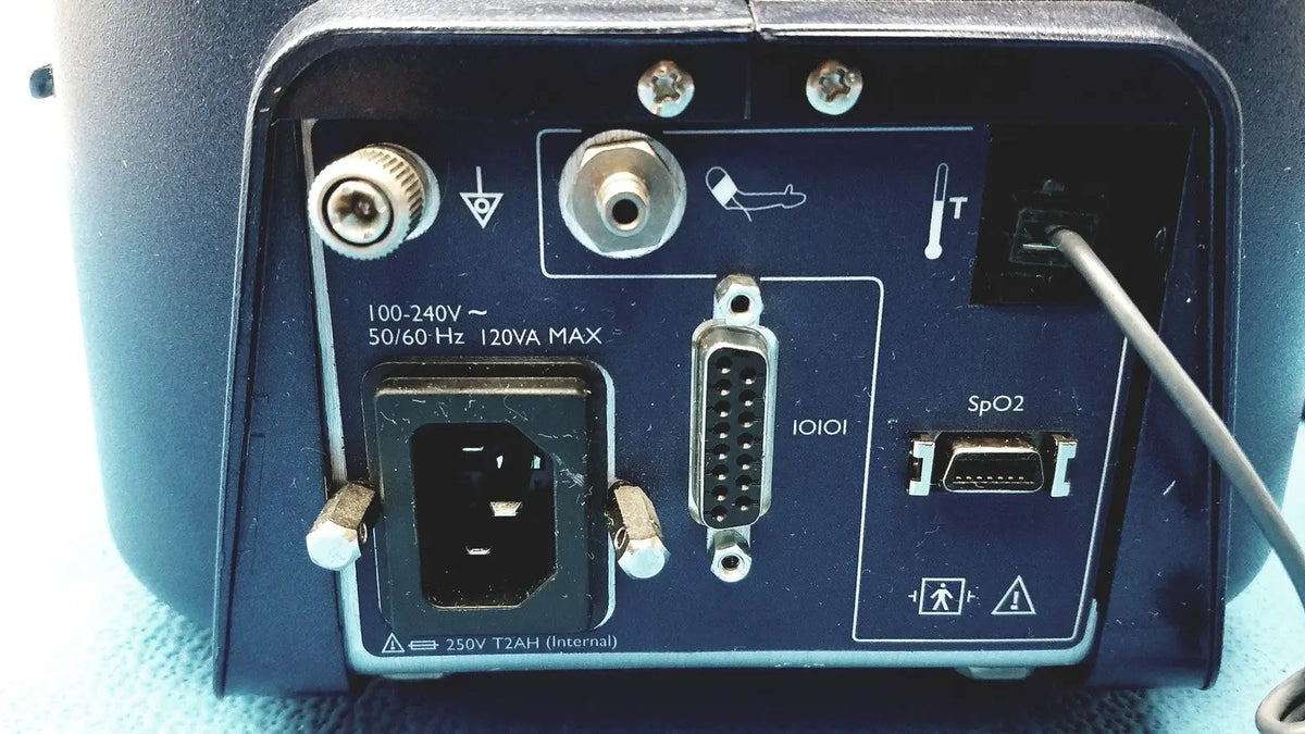 Dark blue rear panel of colin press-mate prodigy ii 2240 patient monitor with power input serial and spo2 sensor ports