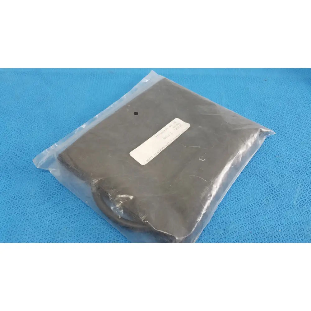Black rectangular power adapter sealed in clear plastic packaging with white label for co430011a thigh blood pressure use