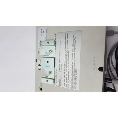 White plastic electrical outlet cover with silver screws and ce mark label for reuse medical equipment conmed 2000 unit