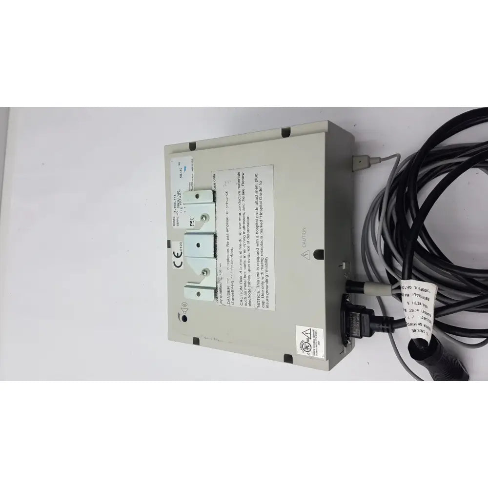 Beige industrial electrical panel of conmed 2000 unit with three white circuit breakers and black cables for reuse medical equipment