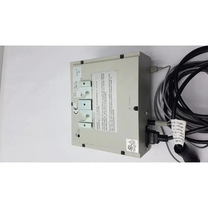 Beige industrial electrical panel of conmed 2000 unit with three white circuit breakers and black cables for reuse medical equipment