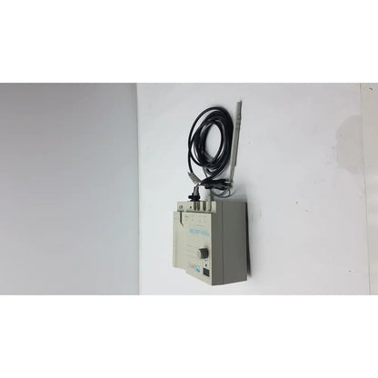 Gray rectangular Conmed 2000 unit medical equipment with coiled black cable and thin metallic probe for reuse medical applications