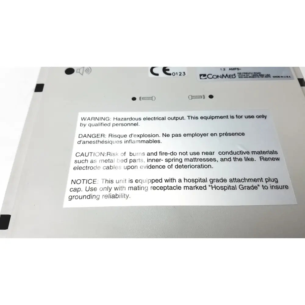 White plastic conmed hyfrecator reuse medical device label with black text ce marking and safety warnings in english and french