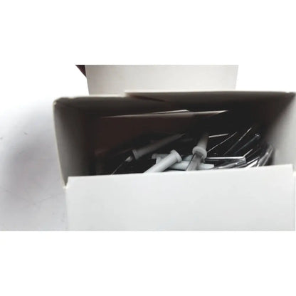 White plastic and metal wall plugs in a box included with conmed hyfrecator 2000 electrosurgical system for reuse medical use