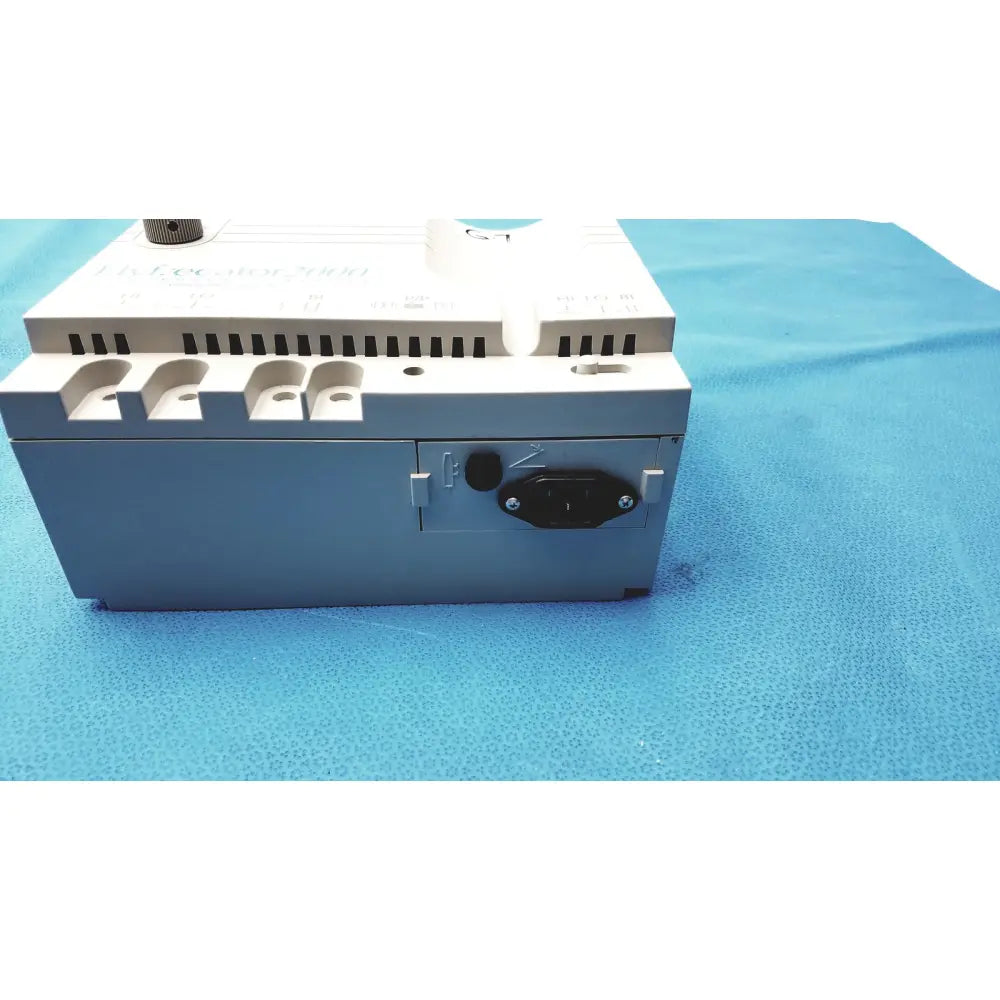 Gray and white industrial power supply unit with black ac input plug on the back side of conmed hyfrecator high frequency equipment