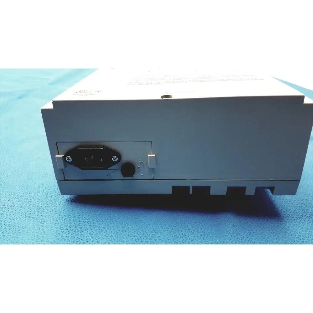 Gray rectangular conmed hyfrecator 2000 high frequency unit power supply with black iec connector and ventilation slots back side