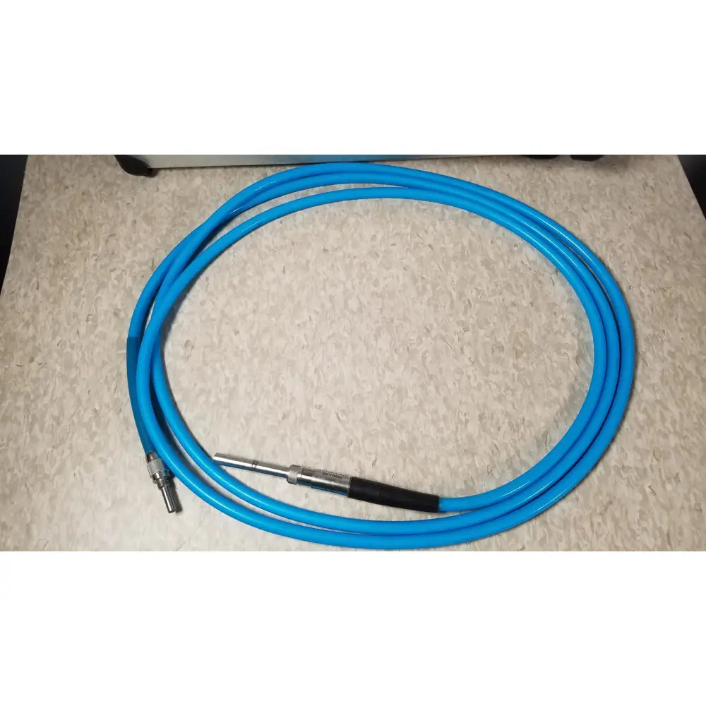 A coiled bright blue flexible hose with metallic connector and black grip for conmed im4123 true hd 1080p urology camera