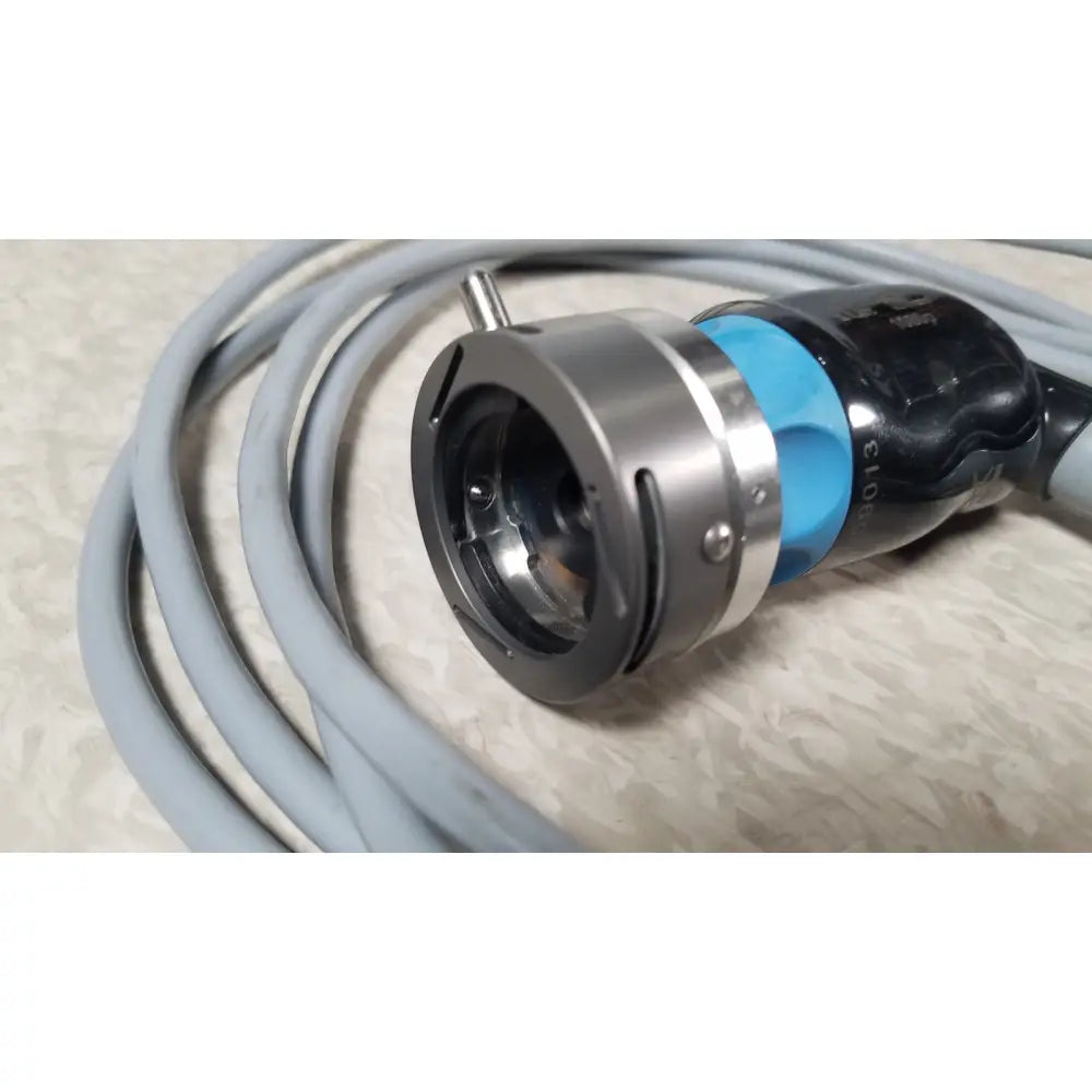 Silver metallic camera lens mount with blue and black housing wrapped in gray cable of conmed im4123 true hd 1080p urology camera head