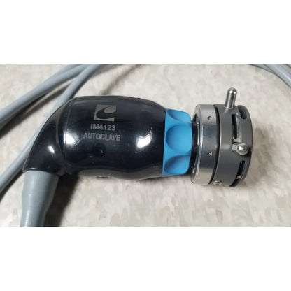 Black and blue conmed im4123 true hd 1080p autoclavable urology camera head with metallic connector labeled im4123 autoclave