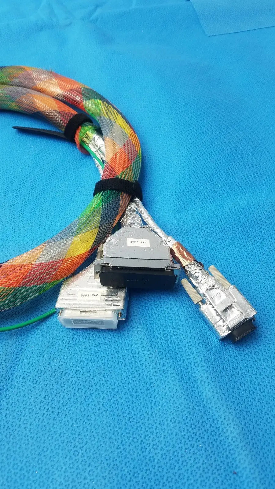 Connector stbu to egse cable featuring a colorful braided rainbow pattern with durable metallic connectors for reuse medical use