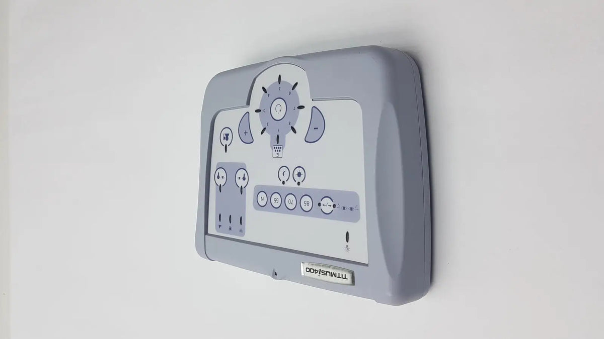 Gray plastic wall-mounted control panel with white display and dials for titmus i400 vision screener use