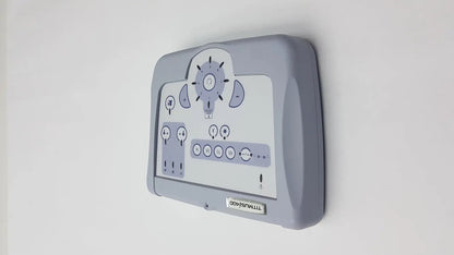 Gray plastic wall-mounted control panel with white display and dials for titmus i400 vision screener use