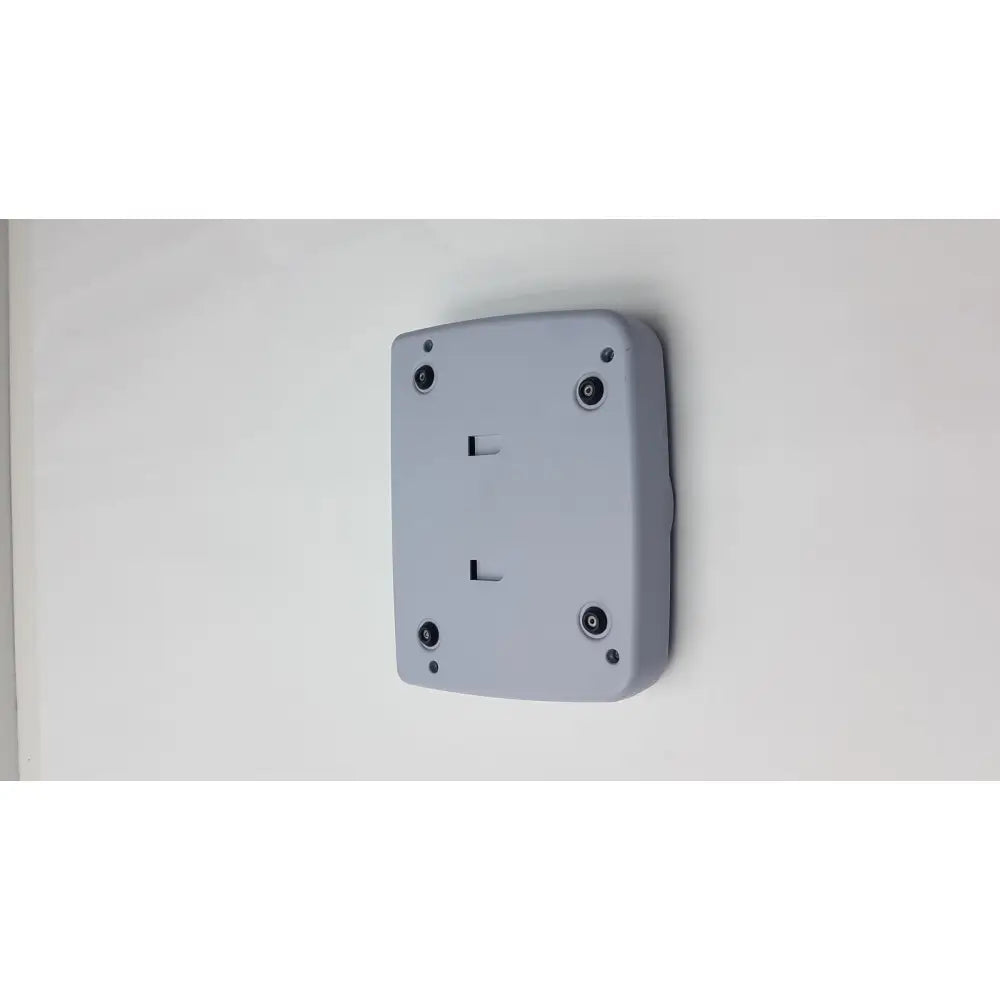 Gray rectangular control panel for titmus i400 vision screener with four black circular screws mounted on wall