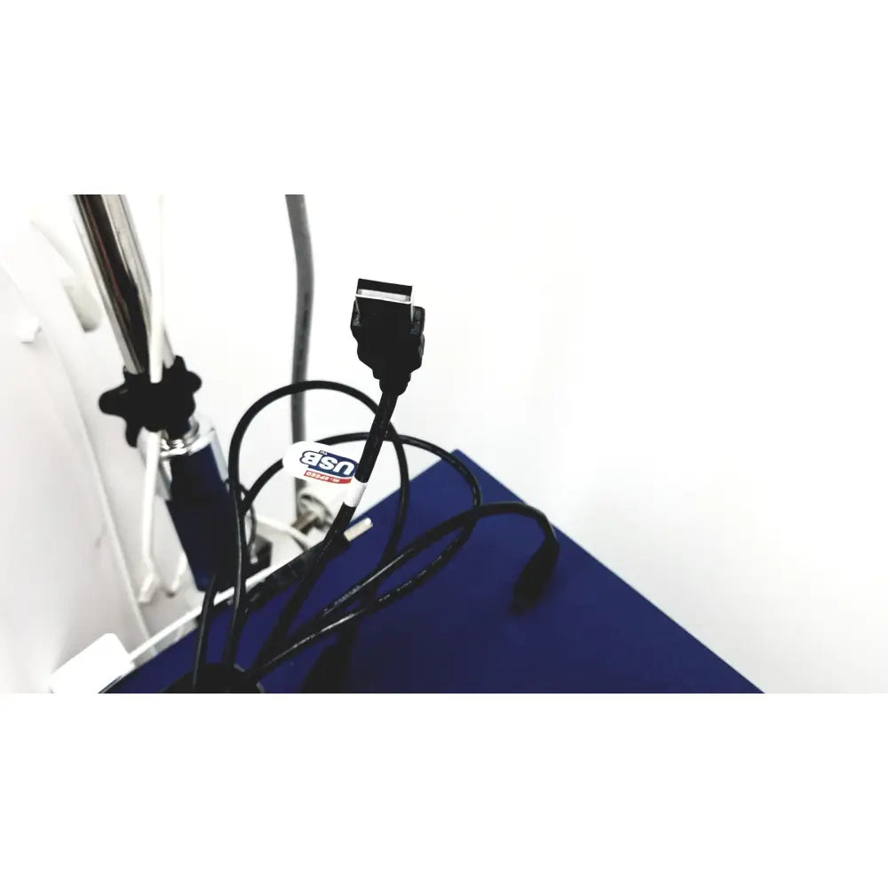 Black usb cable with white bisn label connected to cooper surgical lumax ts pro fiberoptic cystometry system accessory