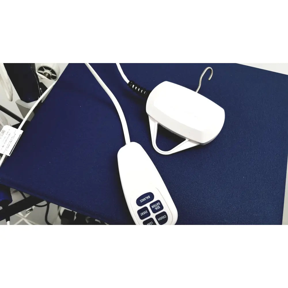 White plastic remote control with blue buttons and hanging device for cooper surgical lumax ts pro fiberoptic cystometry system