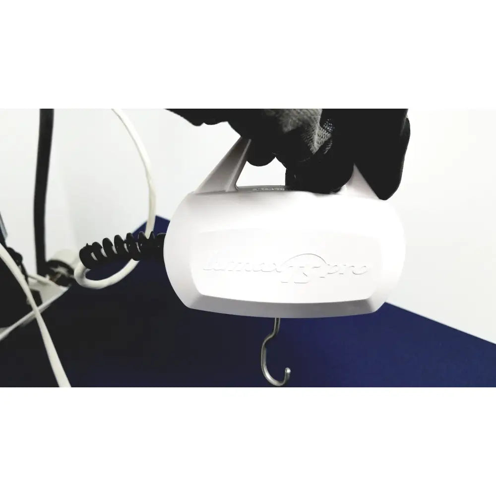 White plastic luggage scale with coiled cord and hook for cooper surgical lumax ts pro fiberoptic cystometry system accessories