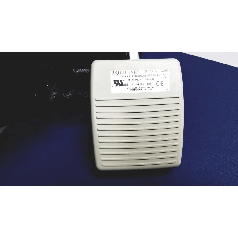Beige aquiline foot pedal switch with horizontal slots and white label for cooper surgical lumax ts pro fiberoptic cystometry system