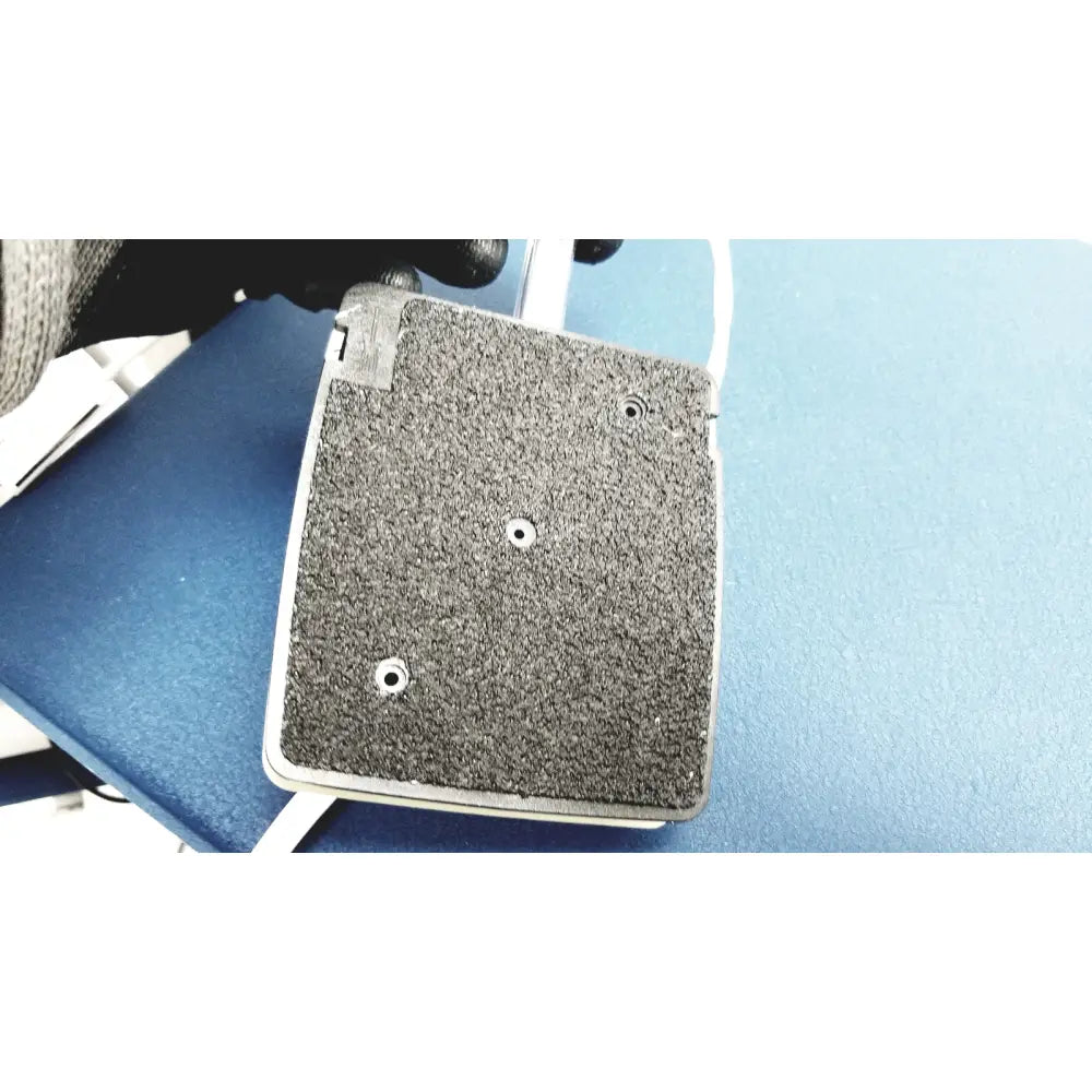 Gray textured grip pad with three circular holes and white border for cooper surgical lumax ts pro fiberoptic cystometry system