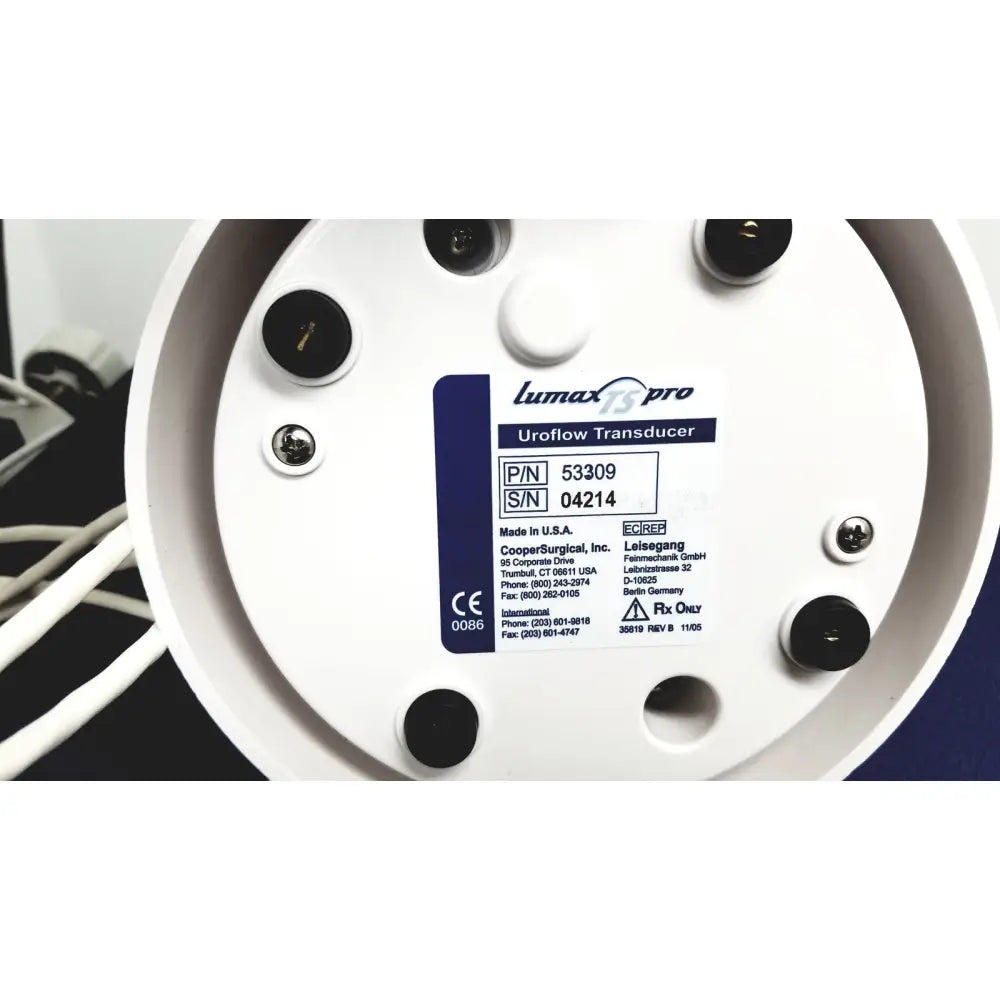 White circular lumax ts pro fiberoptic cystometry transducer by cooper surgical with black screw holes and blue label