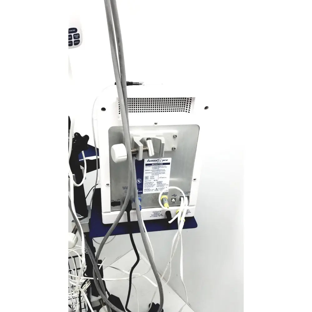 Back view of cooper surgical lumax ts pro fiberoptic cystometry system in white and silver with perforated panel and cables attached
