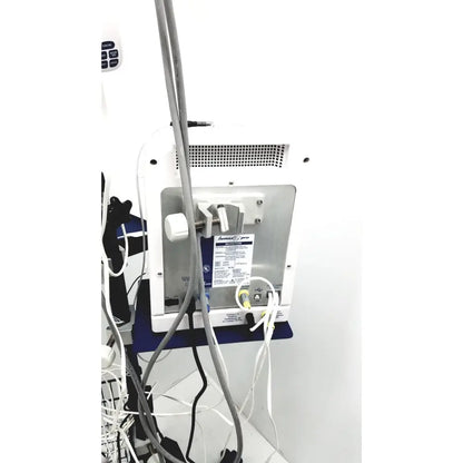 Back view of cooper surgical lumax ts pro fiberoptic cystometry system in white and silver with perforated panel and cables attached