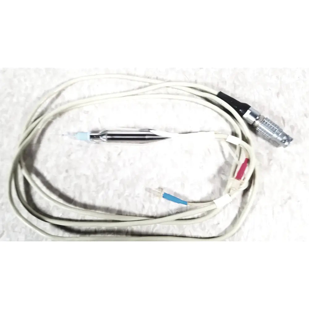 A coiled white cooper vision 390 unipak handpiece with black silver connector and blue probe for alcon phacoemulsifier