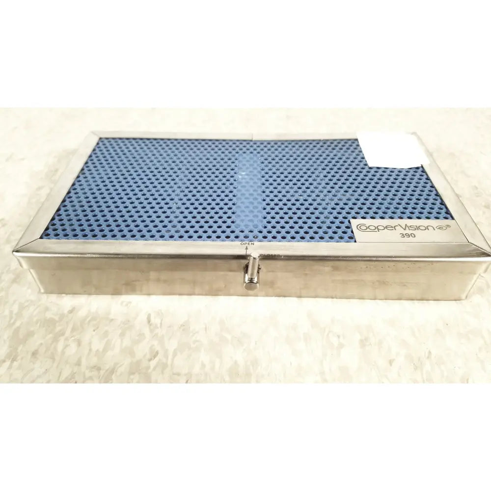 Silver rectangular cooper vision 390 unipak handpiece box with blue perforated lid for alcon phacoemulsifier