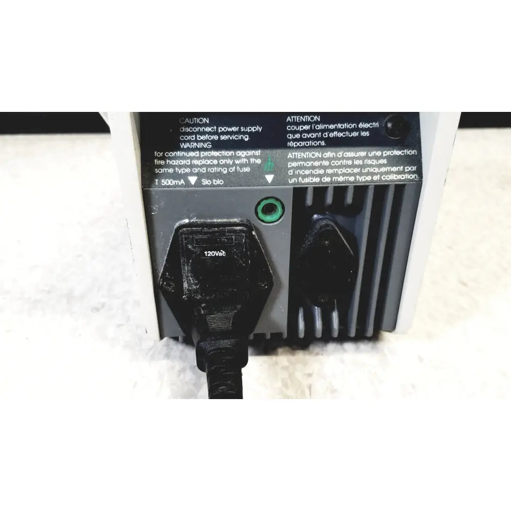 Black 120v power plug connected to back of gray corning 245 ph meter 120v 60hz with bilingual warning labels for reuse medical use