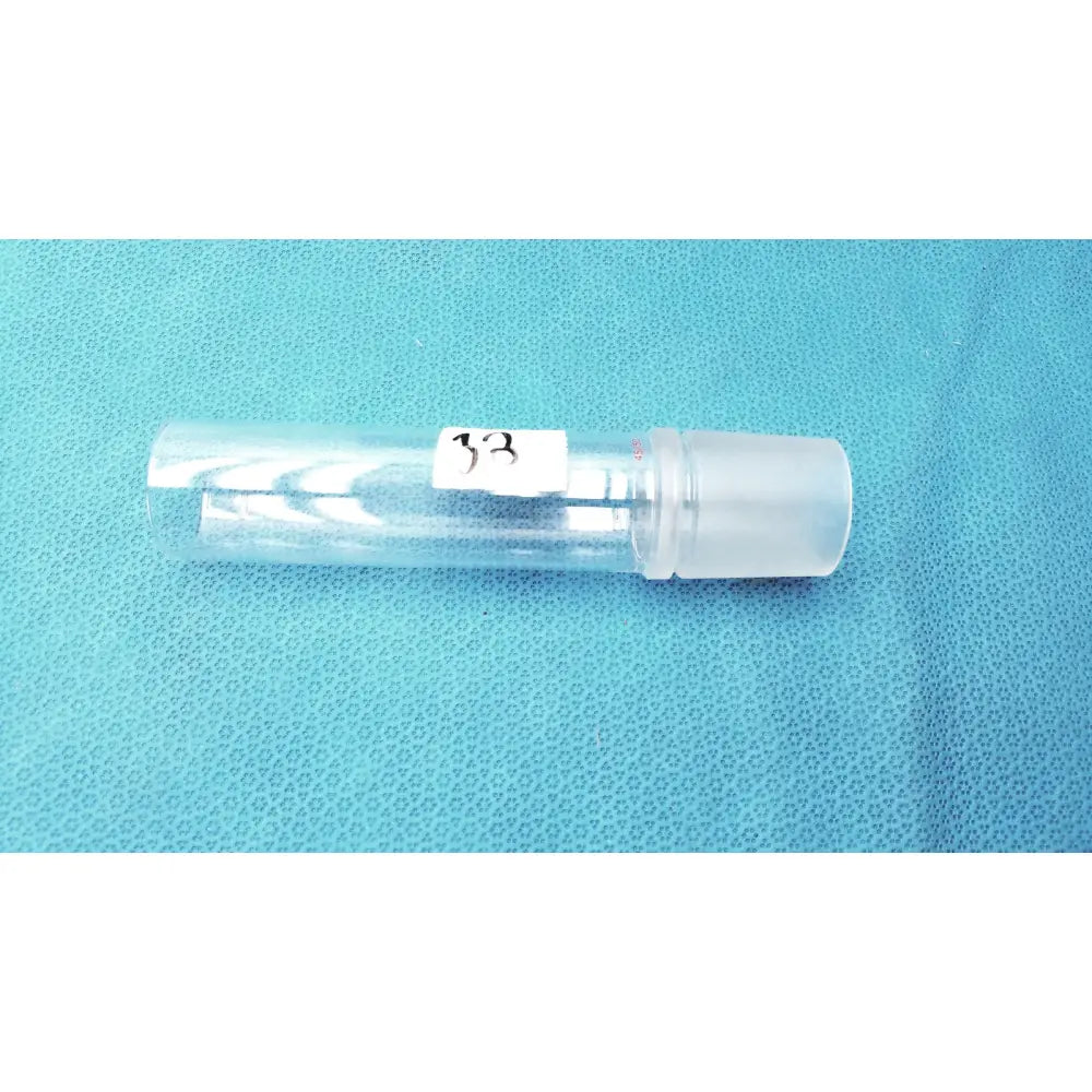 Clear plastic vial with white label 33 and translucent cap used with corning laboratory glassware ground joint adapter