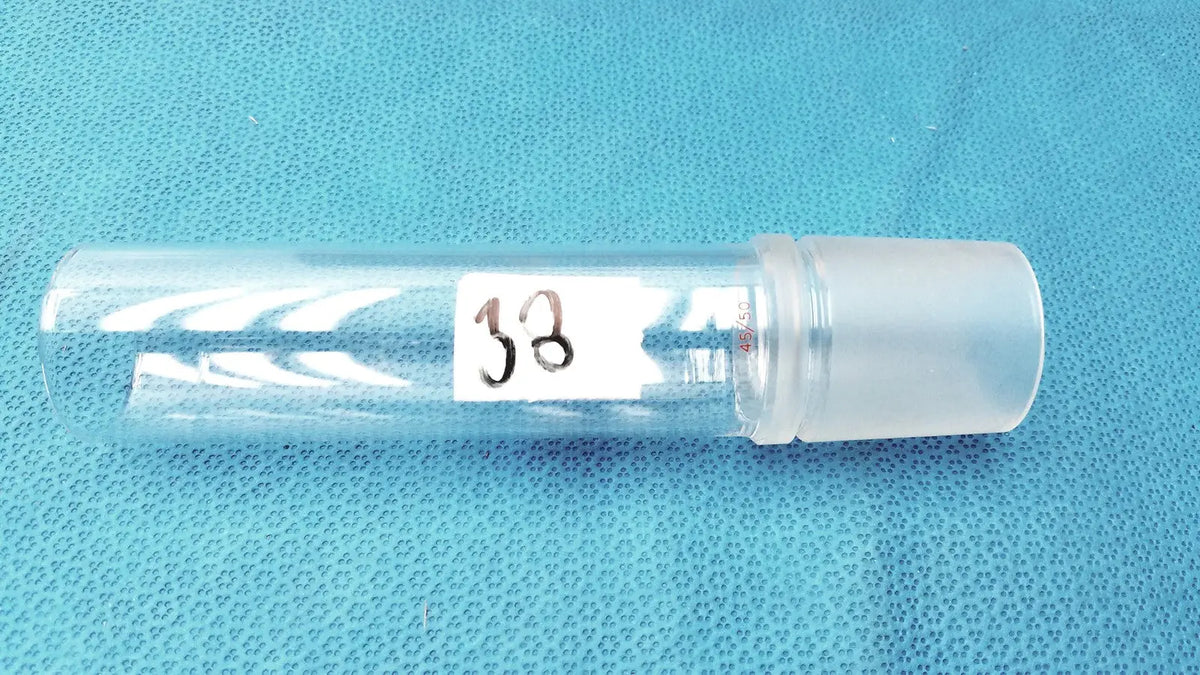 Clear plastic Corning laboratory glassware vial with frosted cap and white label 38 for 45/50 ground joint adapter use