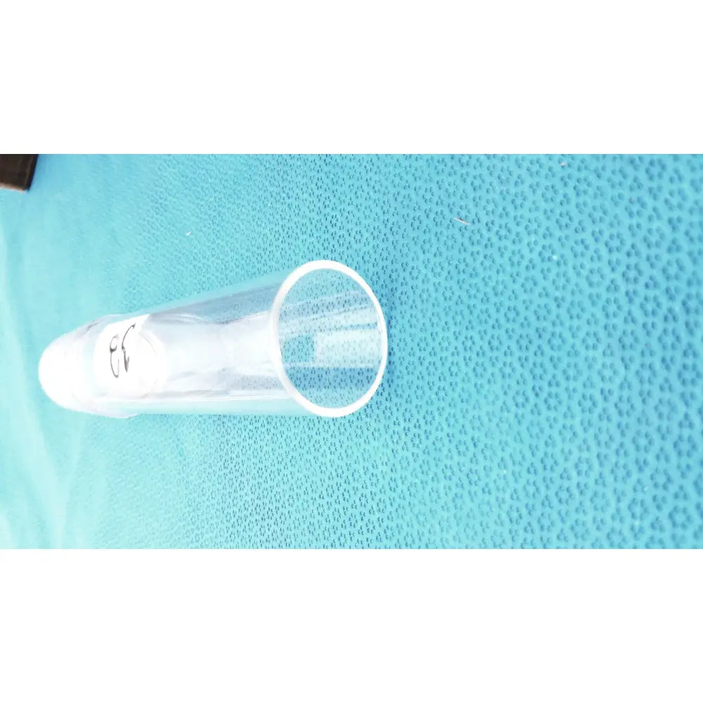 Clear plastic test tube with white cap and black markings as part of corning laboratory glassware ground joint adapter