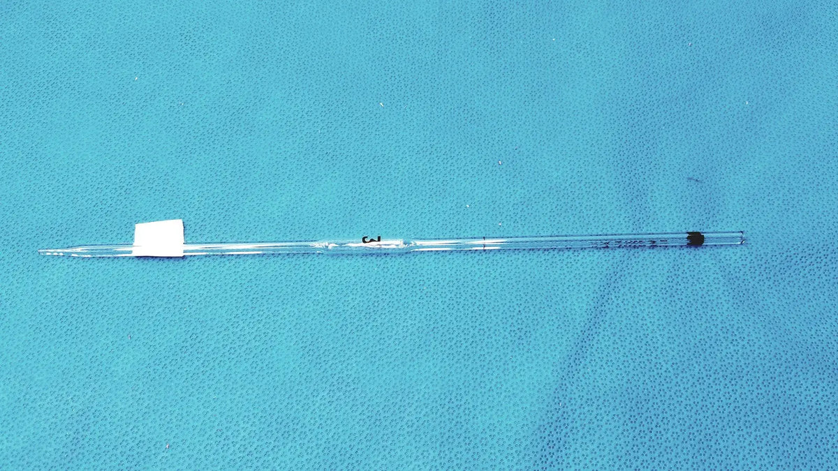 Clear glass corning pyrex 3ml reusable glass volumetric pipette with black rubber stopper and white label at the top