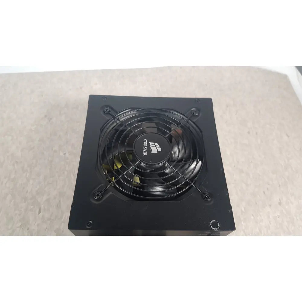 Black corsair ax760 760w fully modular power supply with circular fan and logo on the front panel