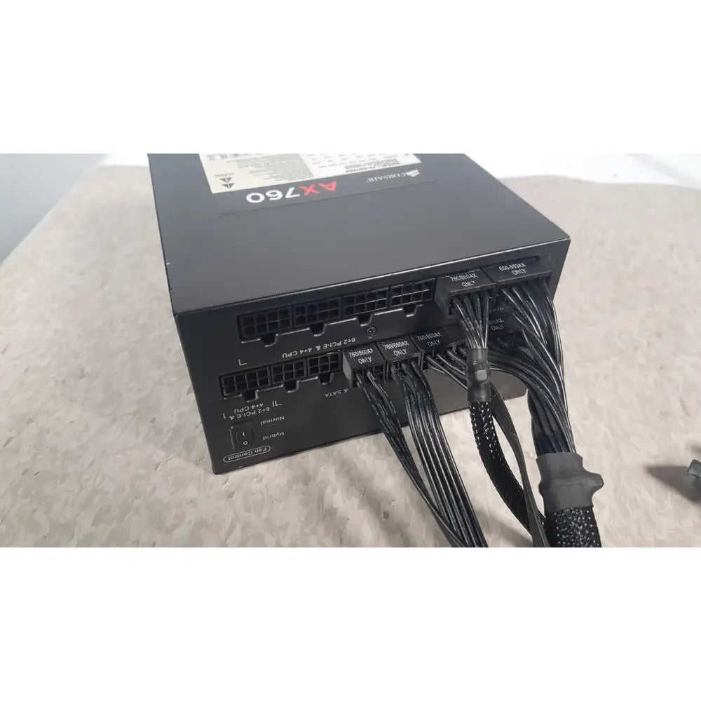 Black corsair ax760 760w fully modular power supply with neatly bundled cables and labeled connectors for easy installation