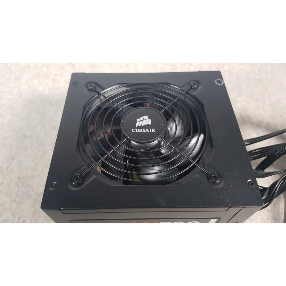 Black corsair ax760 760w fully modular power supply with circular fan and protective grille for efficient cooling