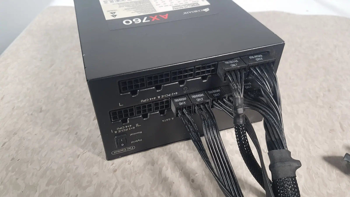 Black corsair ax760 760w fully modular power supply with neatly bundled cables and labeled connectors for easy installation