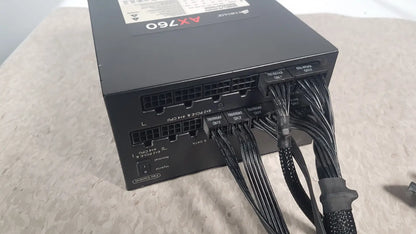 Black corsair ax760 760w fully modular power supply with neatly bundled cables and labeled connectors for easy installation
