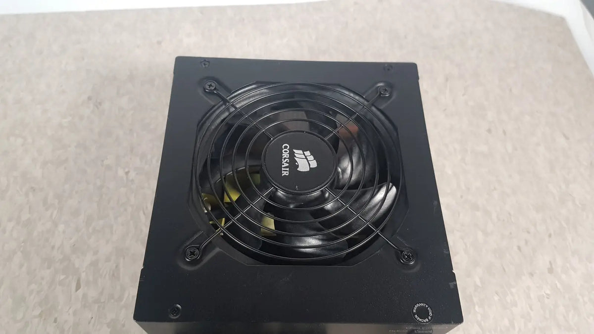 Black corsair ax760 760w fully modular power supply with circular fan and logo on the front panel