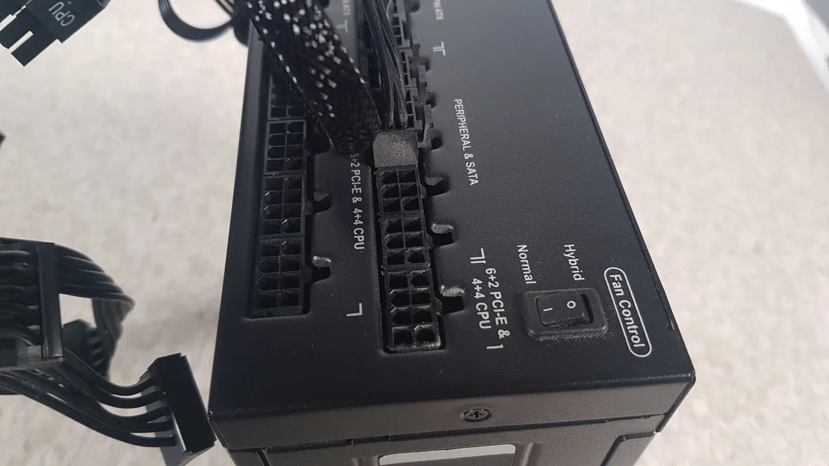 Black corsair ax760 760w fully modular power supply back side showing labeled ports and fan control switch