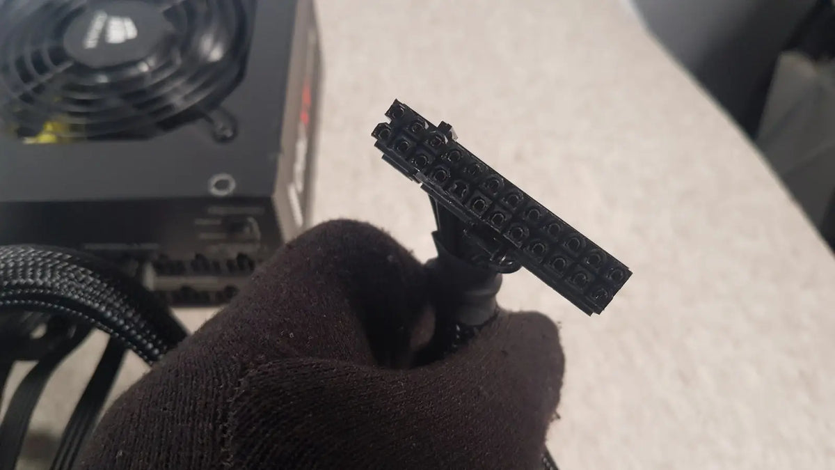 Black plastic 8-pin pcie power connector held in hand for corsair ax760 760w fully modular power supply unit