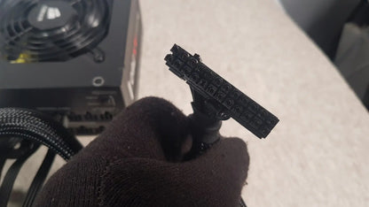 Black plastic 8-pin pcie power connector held in hand for corsair ax760 760w fully modular power supply unit