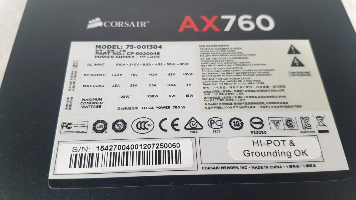 Black corsair ax760 760w fully modular power supply unit with white labeling and specifications visible on the back side