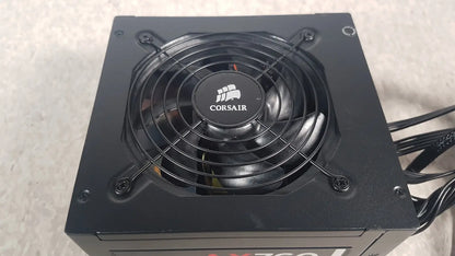 Black corsair ax760 760w fully modular power supply with circular fan and protective grille for efficient cooling