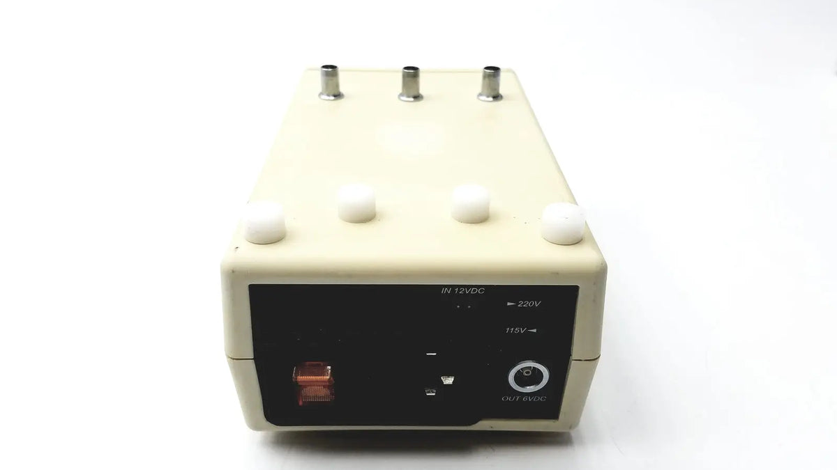 Beige rectangular cosmed k4 b2 metabolic power supply unit with black panel, silver ports, red switch for reuse medical use
