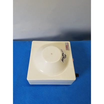 Cream-colored molded plastic fixed position angled rotor with central concave well for costar model 10 mini centrifuge
