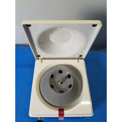 White plastic costar model 10 mini centrifuge with silver metal fixed position angled rotor and red push button